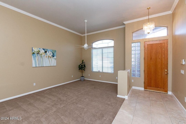 carpeted foyer featuring ornamental molding and ceiling fan with notable chandelier