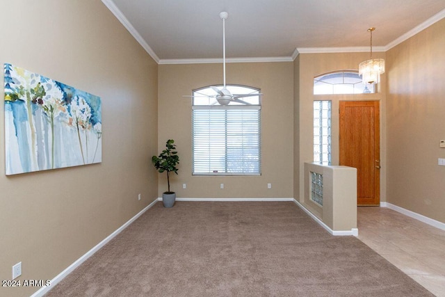 carpeted entrance foyer with crown molding and ceiling fan with notable chandelier