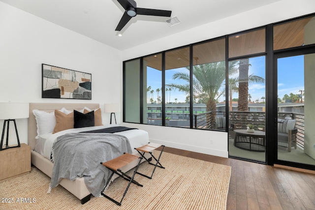 bedroom featuring access to exterior, light hardwood / wood-style flooring, and ceiling fan