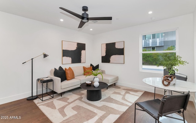 living room featuring ceiling fan and light hardwood / wood-style flooring