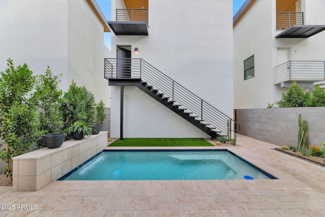 view of swimming pool with pool water feature and a patio area