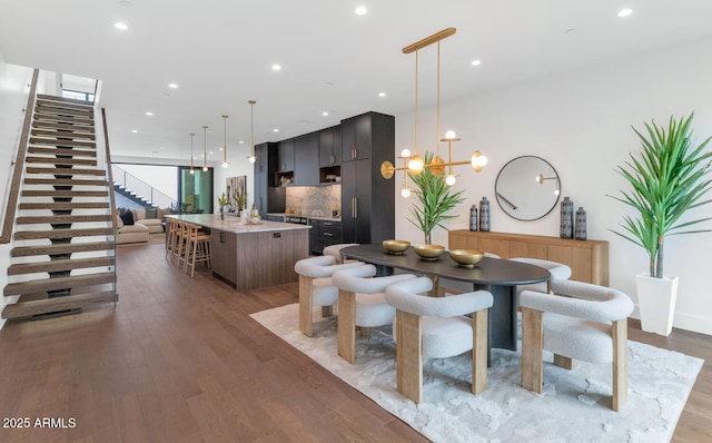 dining area featuring wood-type flooring and a notable chandelier