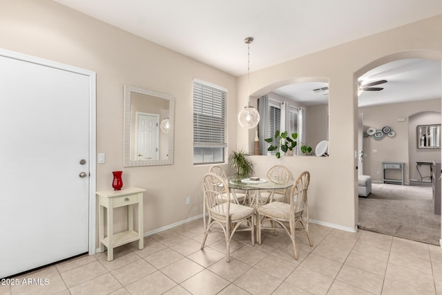 dining space with ceiling fan and light tile patterned floors