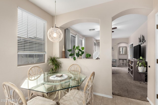 dining space featuring ceiling fan and light tile patterned flooring