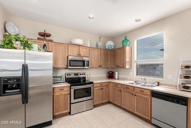 kitchen featuring light tile patterned floors, stainless steel appliances, and sink