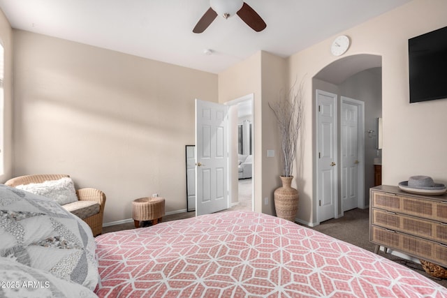 bedroom featuring ceiling fan and dark carpet