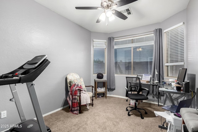 carpeted home office with ceiling fan