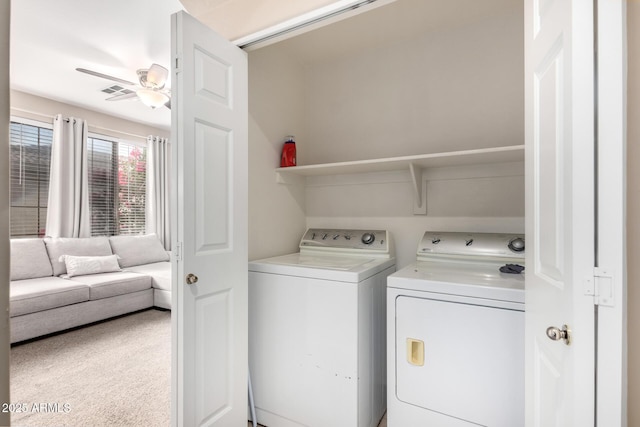 clothes washing area featuring ceiling fan, washer and clothes dryer, and carpet floors