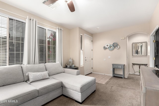 living room with ceiling fan and light colored carpet