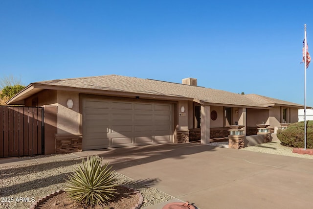 view of front of house featuring an attached garage, fence, stone siding, concrete driveway, and stucco siding