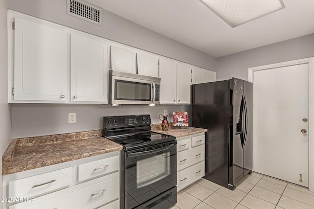 kitchen featuring dark countertops, black appliances, visible vents, and white cabinets