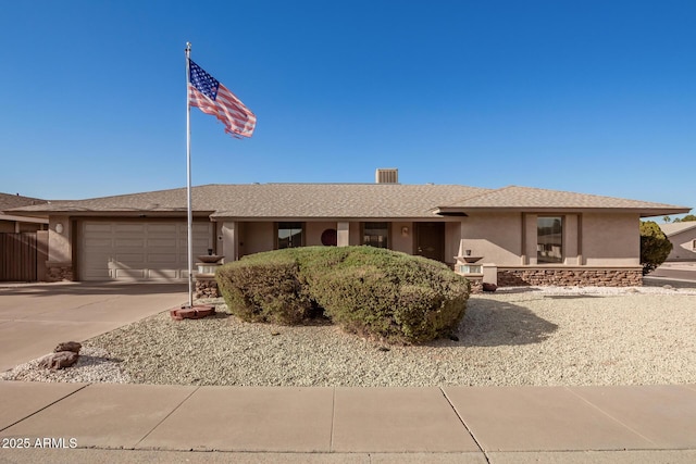 ranch-style home featuring a garage, concrete driveway, roof with shingles, and stucco siding