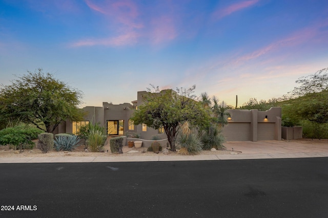 southwest-style home with a garage