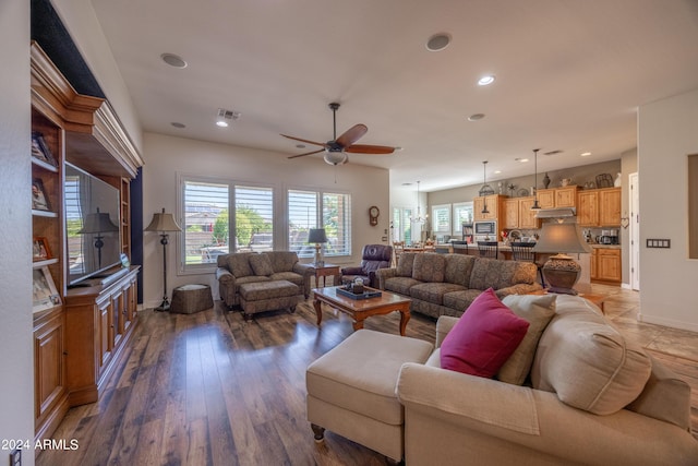 living room with dark hardwood / wood-style floors and ceiling fan