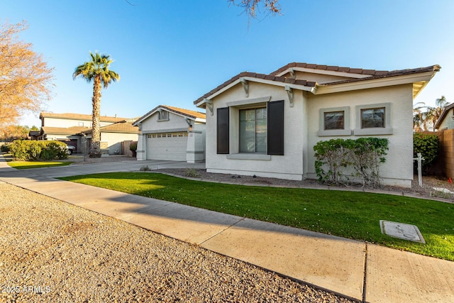 view of front of property featuring a garage and a front lawn