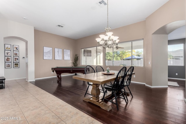 dining space featuring hardwood / wood-style flooring and a notable chandelier