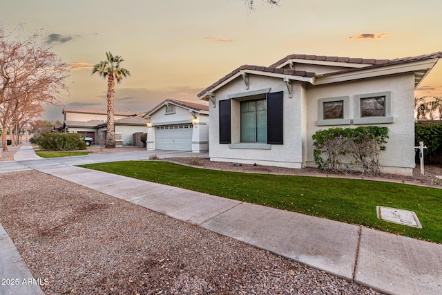 view of front of house featuring a yard and a garage