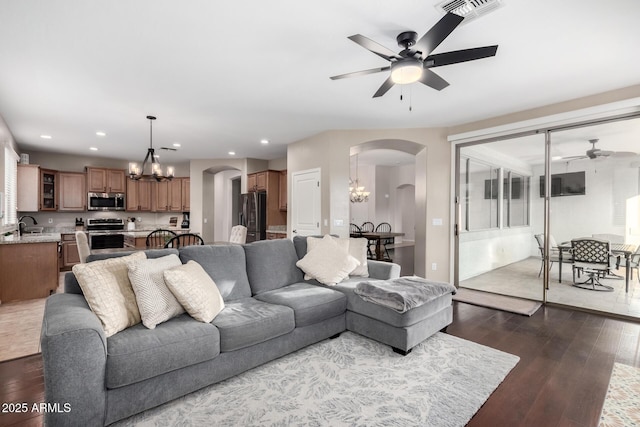 living room with sink, dark hardwood / wood-style floors, and ceiling fan with notable chandelier