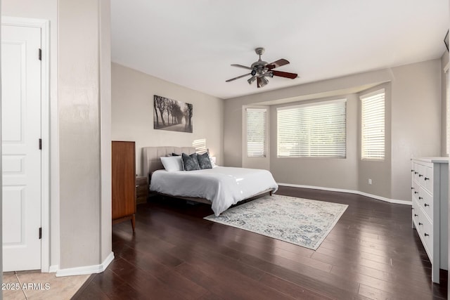 bedroom with dark wood-type flooring and ceiling fan