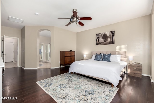 bedroom with dark wood-type flooring, ceiling fan, and ensuite bathroom