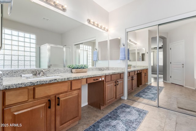 bathroom with vanity, an enclosed shower, and tile patterned flooring