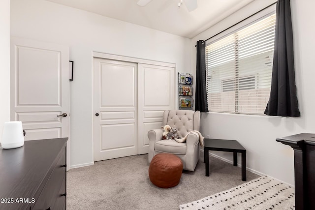 sitting room featuring ceiling fan and light carpet