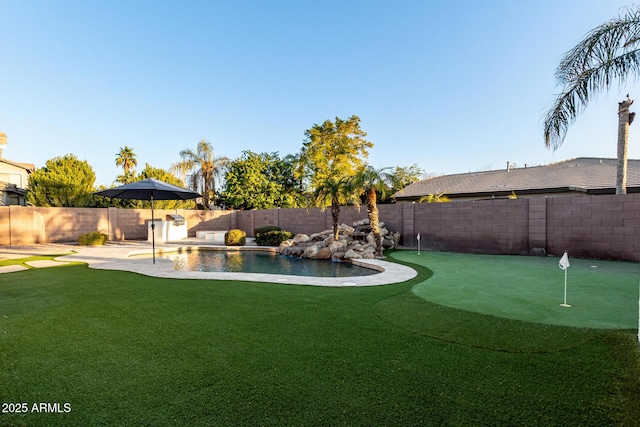 view of yard with pool water feature, a fenced in pool, and a patio area