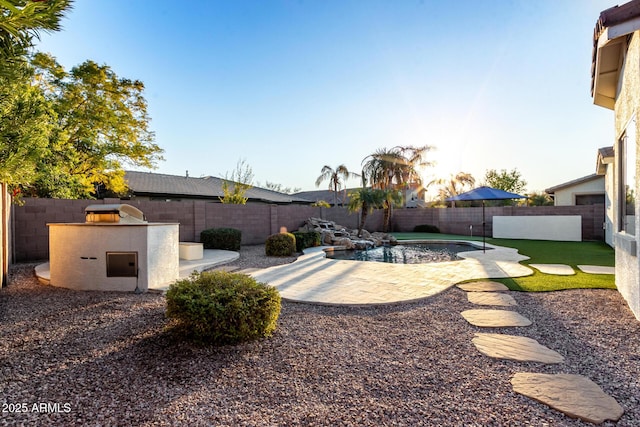 view of yard featuring area for grilling, a fenced in pool, and a patio