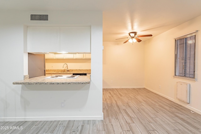 empty room featuring ceiling fan and light hardwood / wood-style flooring