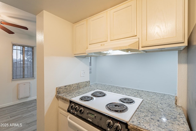 kitchen with ceiling fan, electric range, light stone counters, and light hardwood / wood-style floors