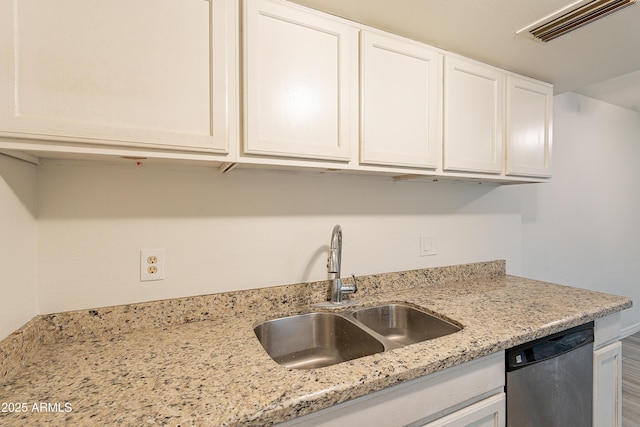 kitchen with dishwasher, sink, white cabinets, and light stone counters