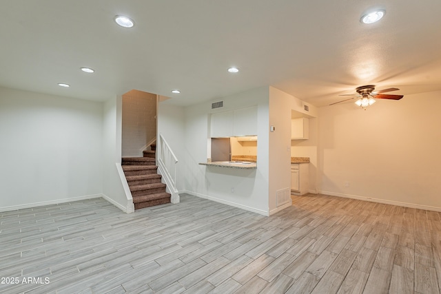 unfurnished living room with ceiling fan and light hardwood / wood-style floors