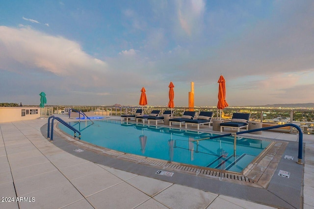 pool at dusk with a patio