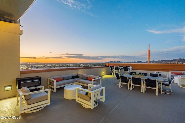 patio terrace at dusk featuring an outdoor living space