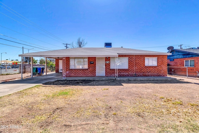 ranch-style home featuring driveway, fence, a carport, and brick siding