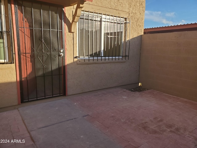 view of gate with a patio