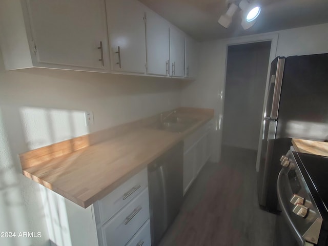 kitchen featuring a sink, white cabinets, light countertops, appliances with stainless steel finishes, and dark wood-style floors