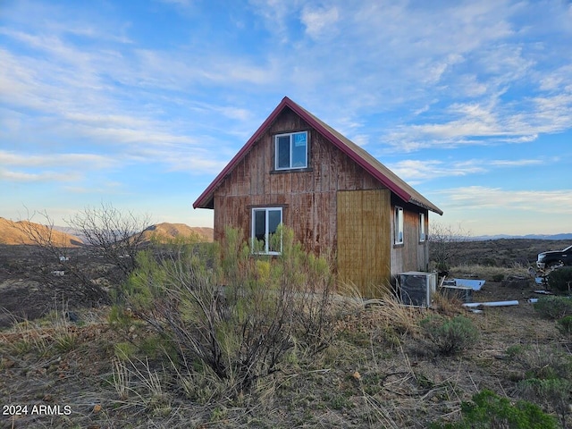 view of side of property with central air condition unit