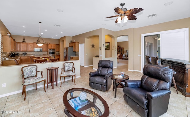 6133 W Fetlock Ter, Phoenix, AZ 85083 - living room with a ceiling fan, arched walkways, light tile patterned flooring, baseboards, and recessed lighting