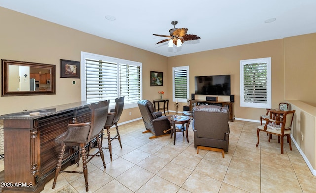 6133 W Fetlock Ter, Phoenix, AZ 85083 - living room featuring ceiling fan, light tile patterned floors, baseboards, and a dry bar