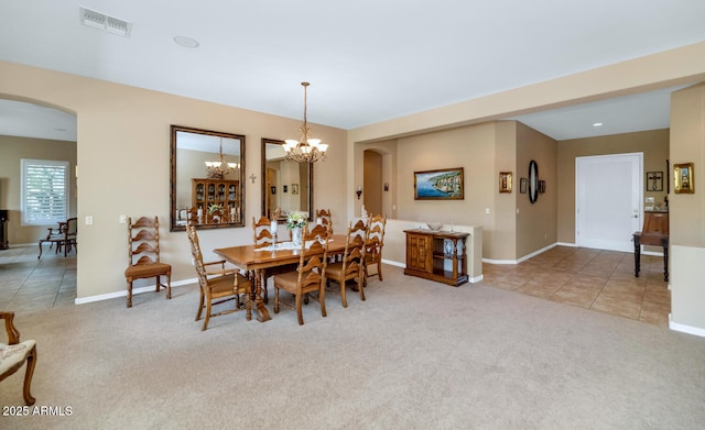 6133 W Fetlock Ter, Phoenix, AZ 85083 - dining space featuring arched walkways, carpet floors, a chandelier, and baseboards
