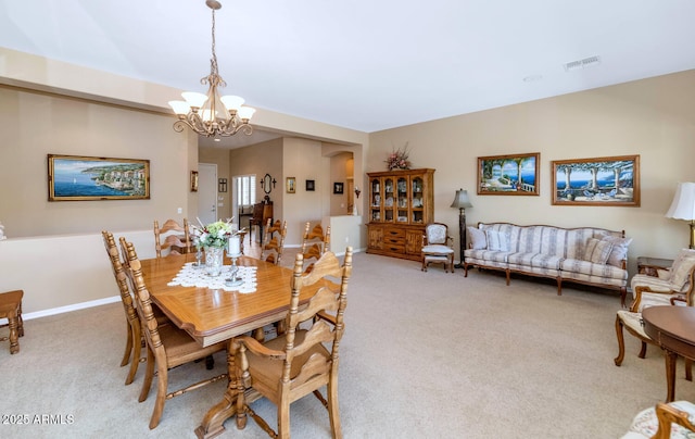 6133 W Fetlock Ter, Phoenix, AZ 85083 - dining area with light carpet, a chandelier, and baseboards