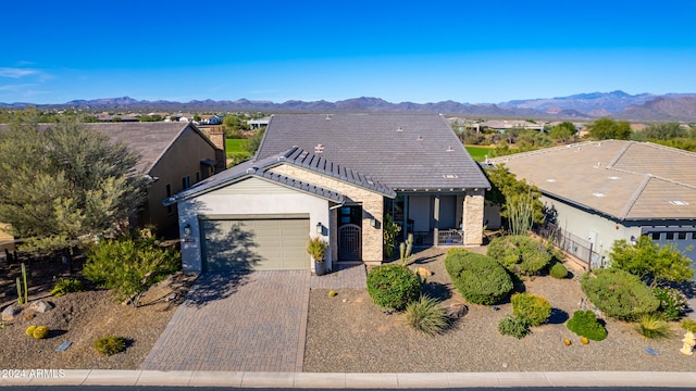 view of front facade featuring a mountain view and a garage