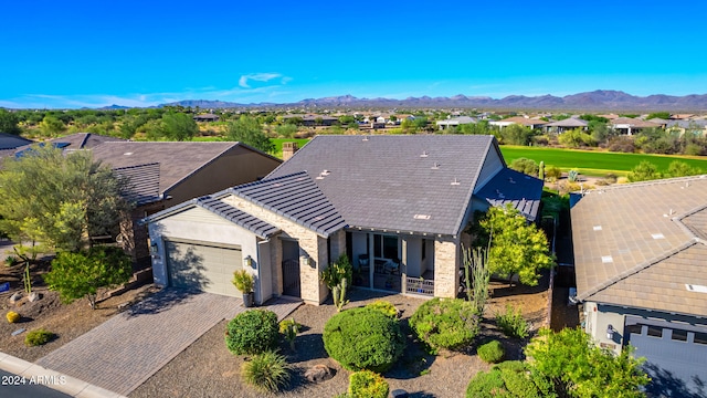 17756 E Silver Sage Ln, Rio Verde, AZ 85263 - view of front facade with a garage, decorative driveway, a mountain view, and stone siding