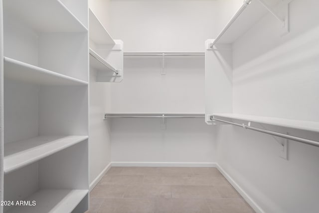 spacious closet featuring light tile patterned floors