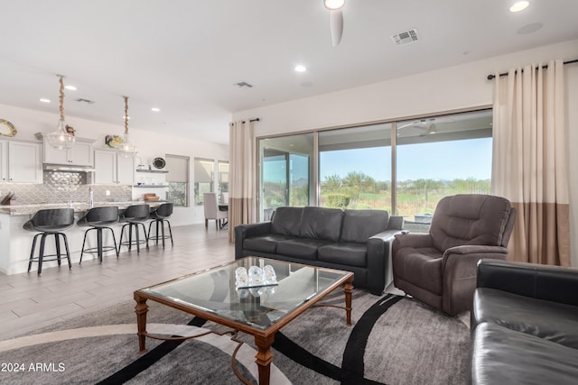 living room featuring ceiling fan and light wood-type flooring