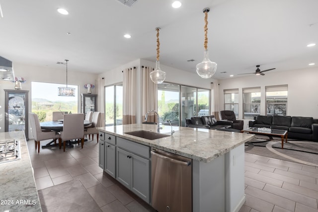 kitchen with sink, hanging light fixtures, and a wealth of natural light