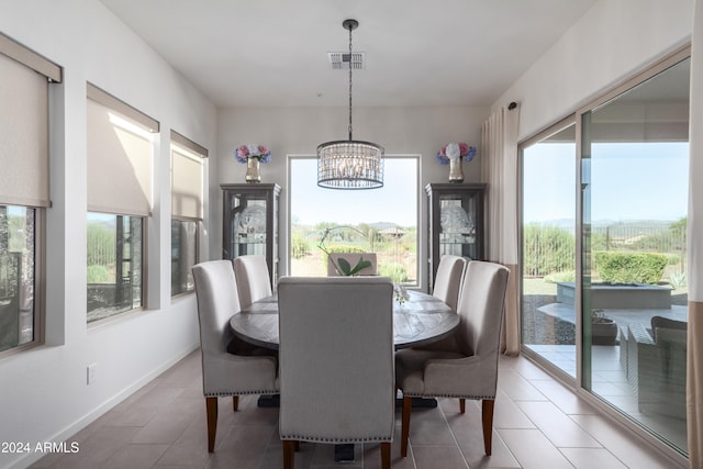 tiled dining area with a notable chandelier and plenty of natural light