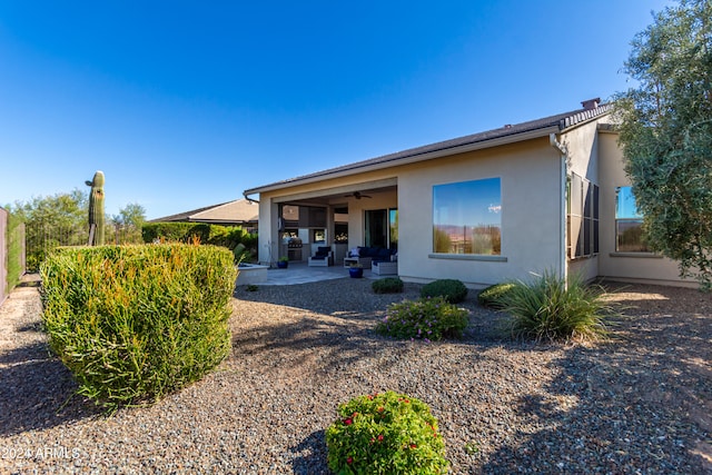 back of property featuring a patio area and ceiling fan