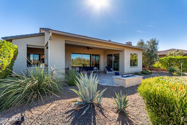 17756 E Silver Sage Ln, Rio Verde, AZ 85263 - rear view of house with a ceiling fan, stucco siding, a patio area, and a fire pit